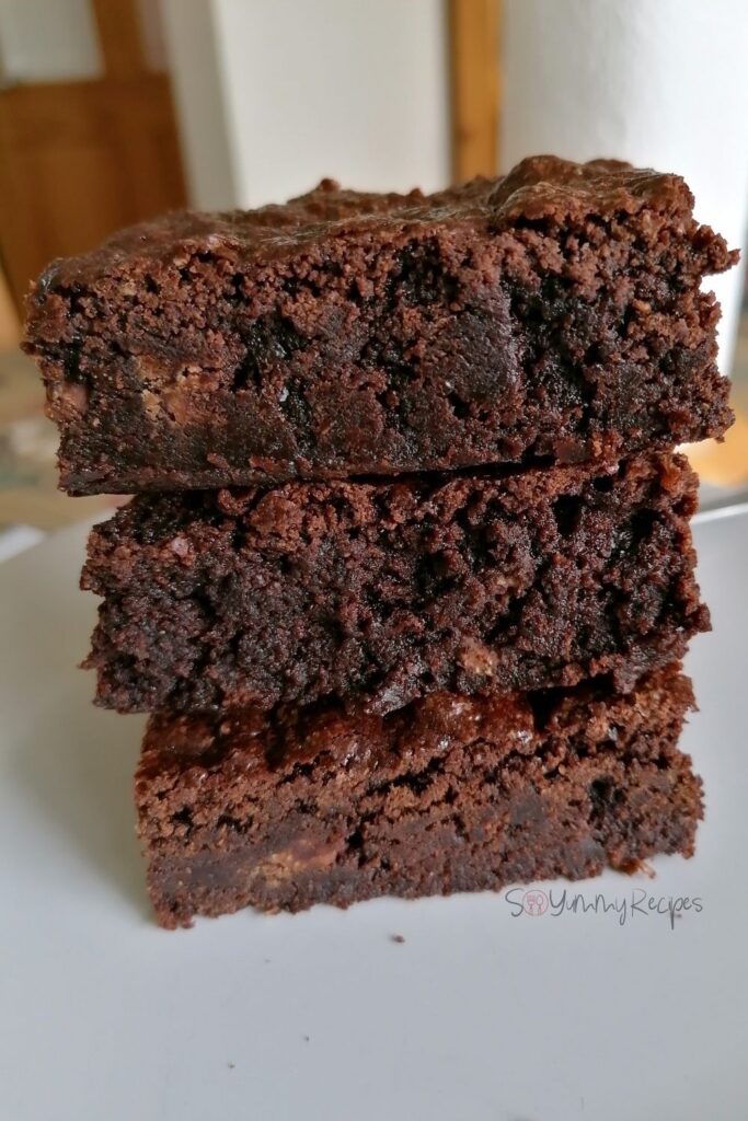 a stacked three pieces of dairy free chocolate brownies