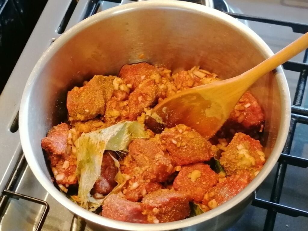 raw beef covered with spices and herbs for rendang
