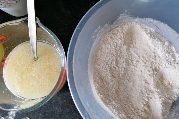a jar of egg mixture and a bowl of flour mixture