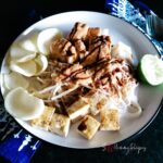 A round plate of Ketoprak Jakarta with some crackers
