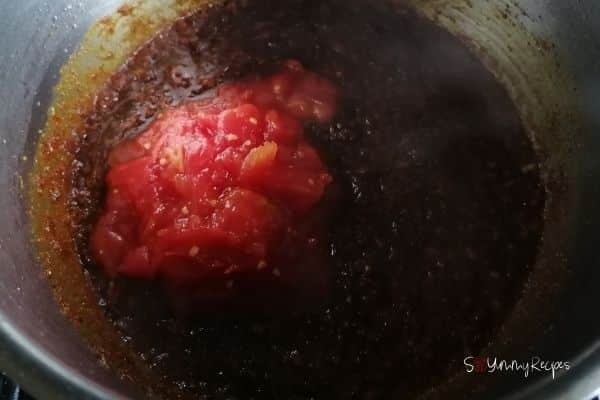 chopped tomatoes in the spices