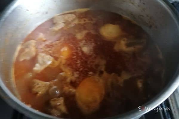 meat and potato curry in cooking pan
