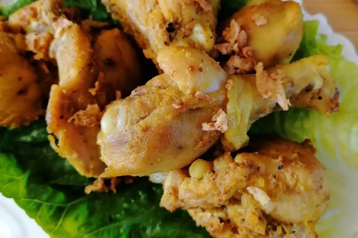 Indonesian fried chicken pieces on a lettuce