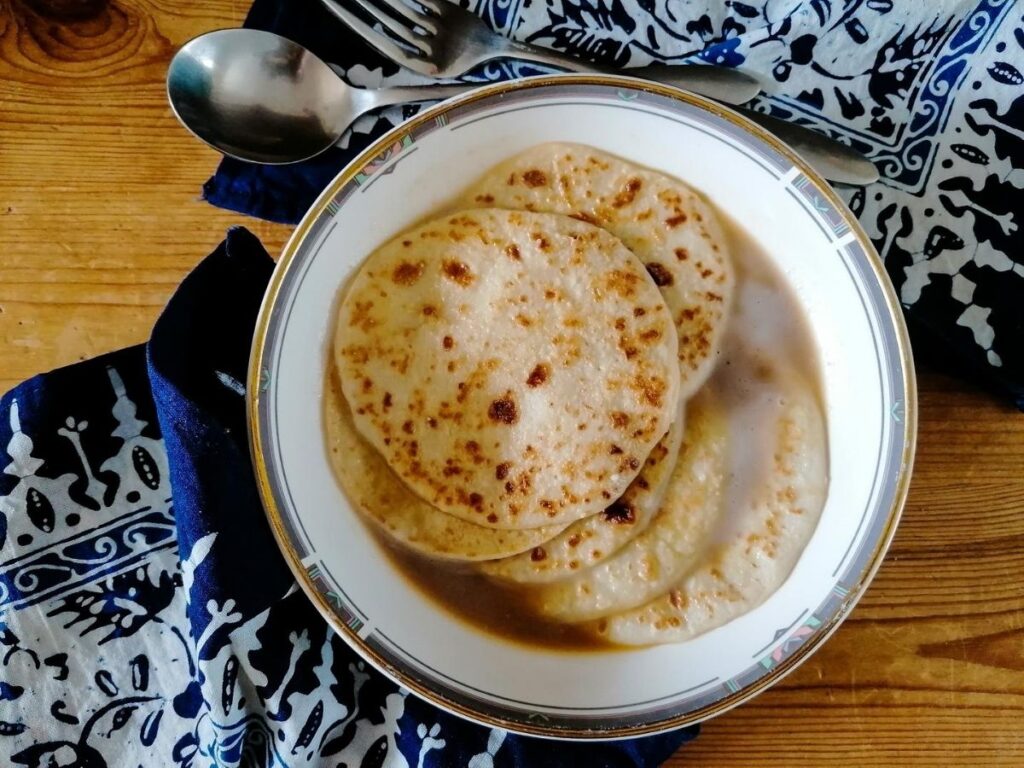 A bowl of serabi kuah, the Indonesian pancakes with sugar syrup and coconut milk