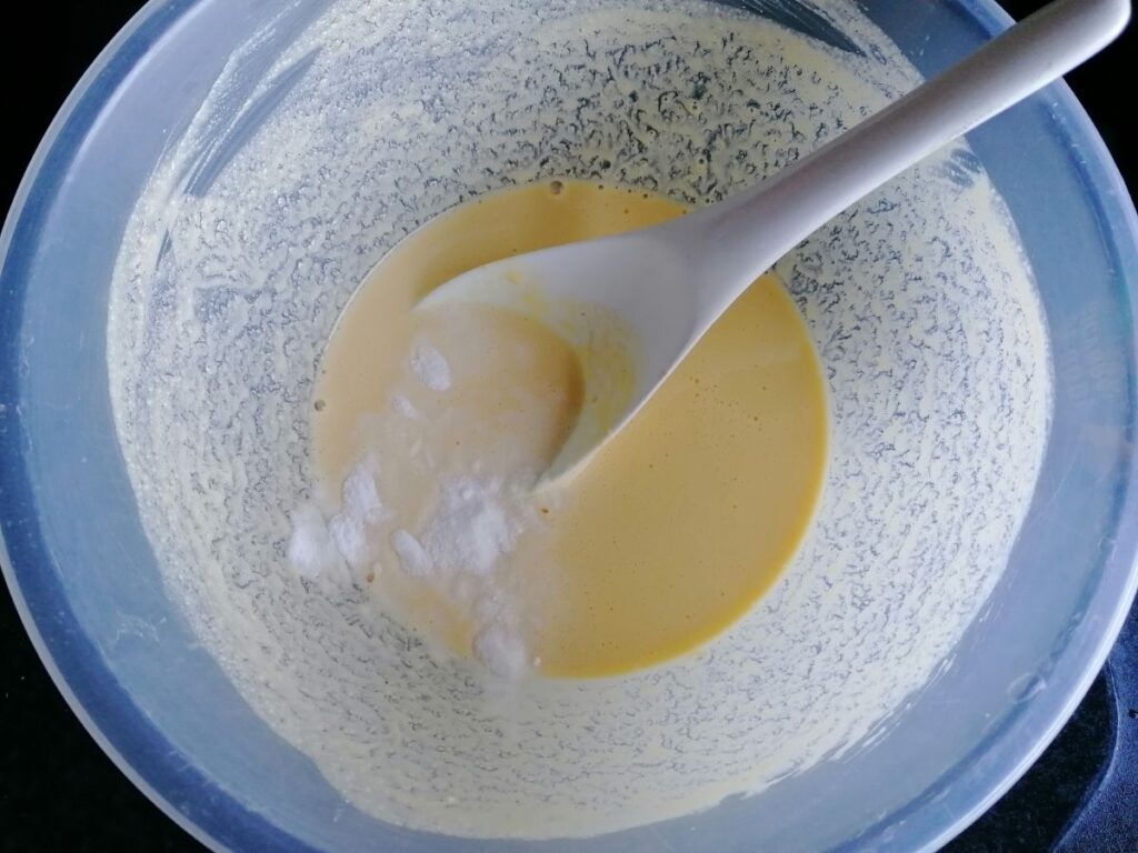 dhokra mixture and a mixing spoon
