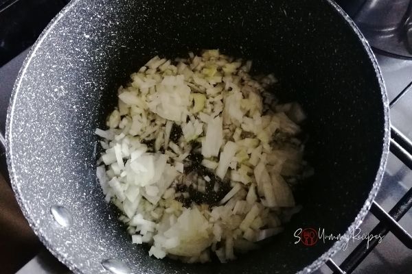 frying chopped onions in a pan