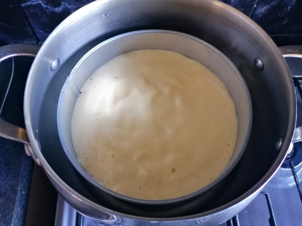a tin of dhokra batter in a steamer
