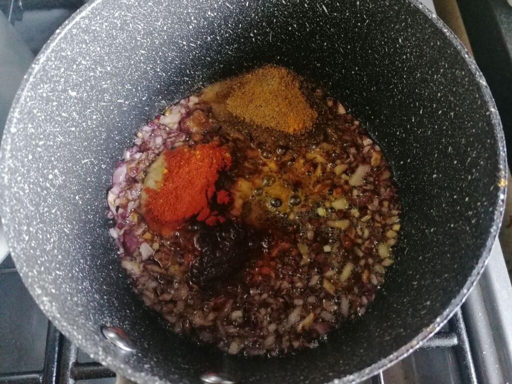 frying onions with spices for aubergine curry