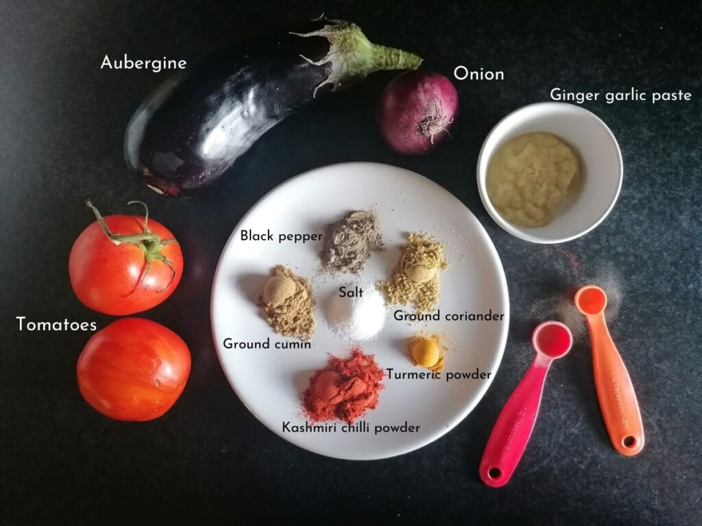 Tomatoes, aubergine, onion, and some spices to make aubergine curry