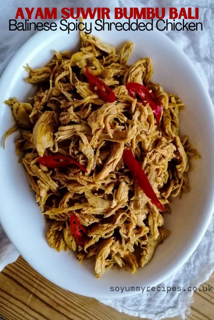 an oval dish of ayam suwir bumbu bali - the shredded chicken in Balinese spices with overlay texts