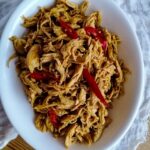 Ayam Suwir Bumbu Bali - shredded chicken with Balinese spices in an oval white dish
