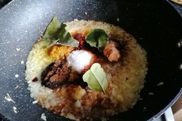 Spices and herbs frying on a pan
