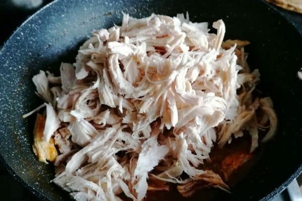 shredded chicken in a pan 