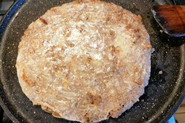 cooking the paratha with the butter