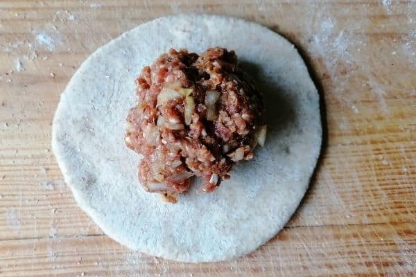 chapati dough with minced meat on the top