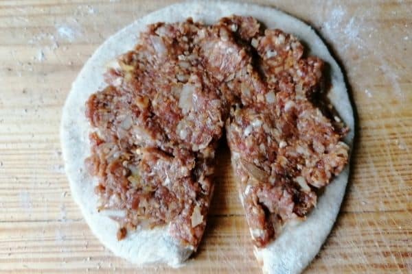 Keema paratha dough with minced meat on the top