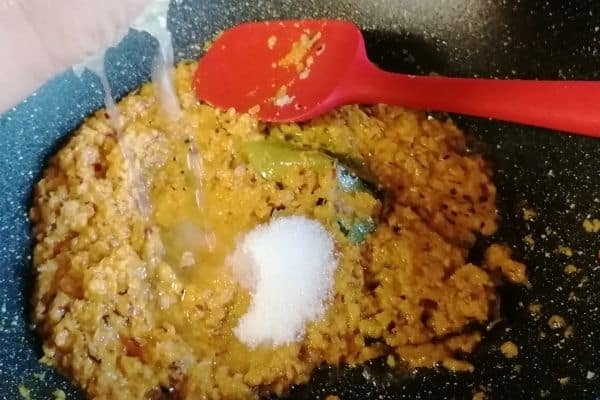 Adding the lemon juice to the spices