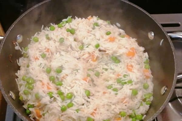 cooking the vegetables and rice until the water evaporates