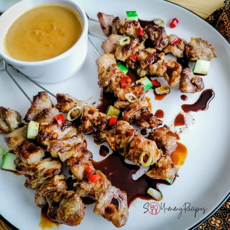 Indonesian lamb satay with a bowl of peanut sauce