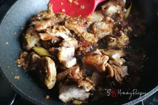 lamb meat in spices on the pan