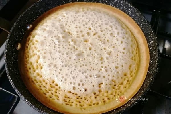 half cooked pancake on the pan