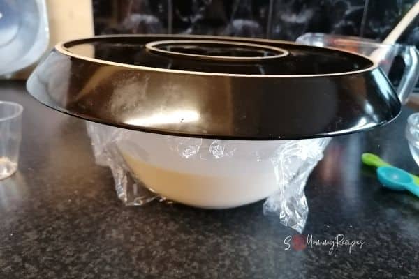 pancake batter in a bowl covered with a plate