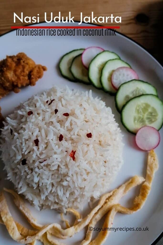 Rice, cucumber slices, fried chicken and omelette slices with overlay text