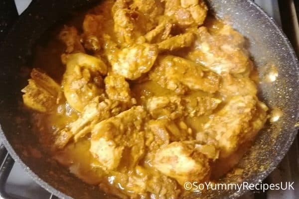 almost cooked chicken curry with some juices