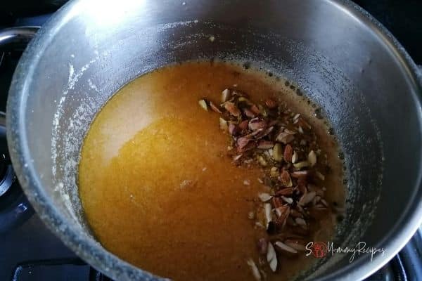 adding nuts in semolina pudding mixture
