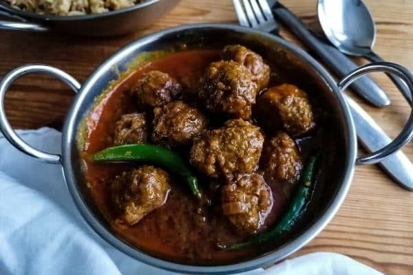 ready cooked lamb kofta curry in a metal bowl 