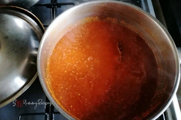cooking blended chillies in a pan