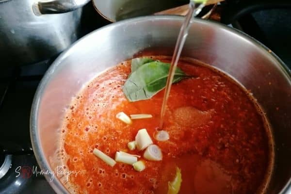 adding oil into blended chillies