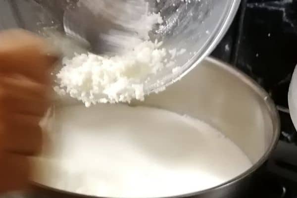 adding rice into the milk