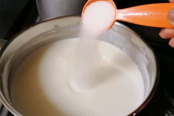 adding sugar to milk mixture