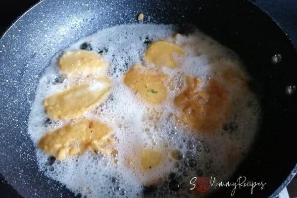 potato slices frying in a pan