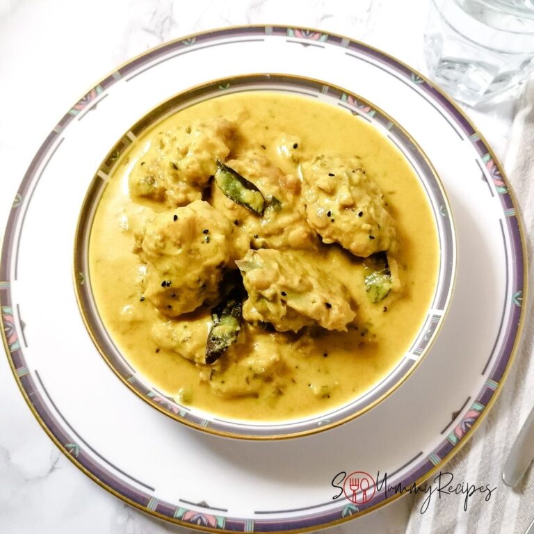 a bowl of kadhi pakora - pakistani dumplings in yoghurt sauce