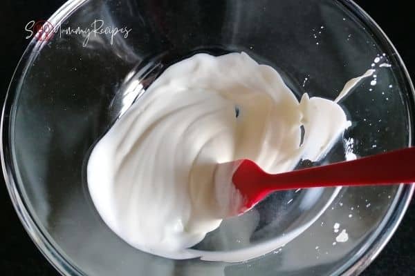 plain yoghurt in a bowl with a red spatula