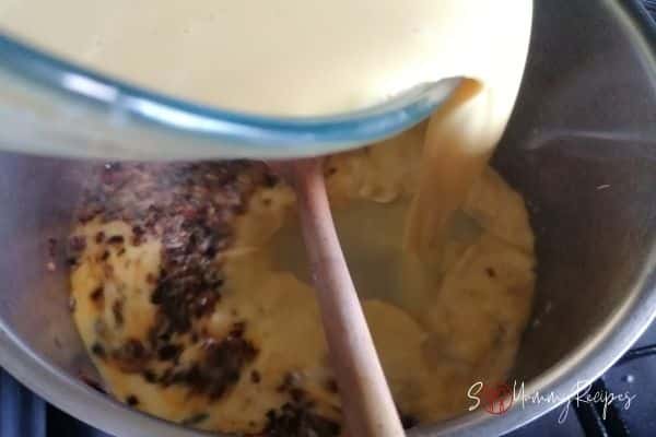adding yoghurt mixture to the spices