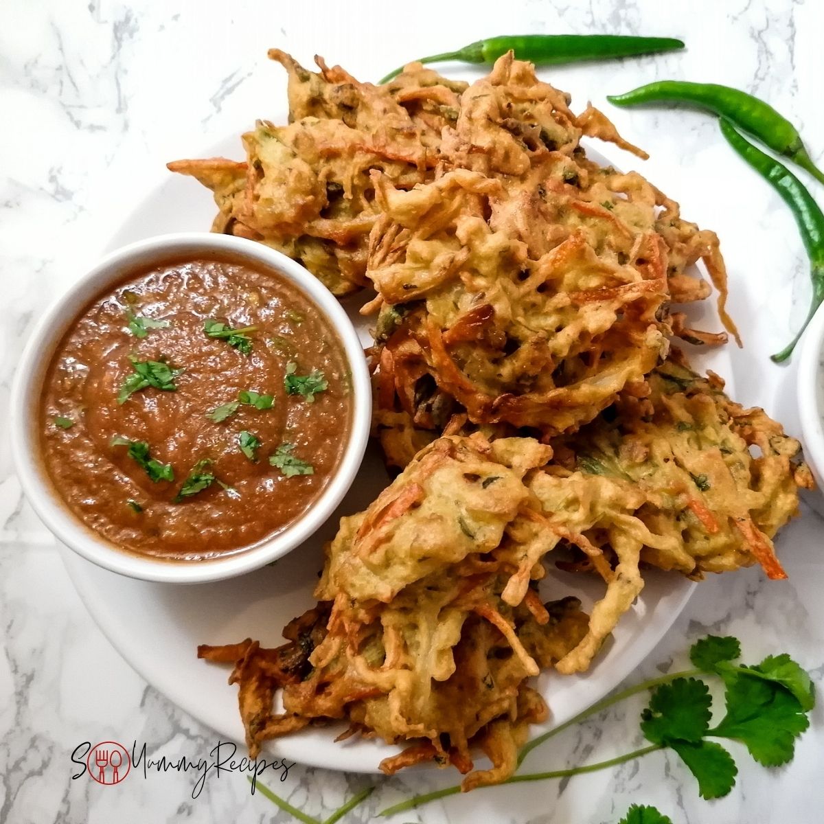 vegetable pakoras and a bowl of chilli tomato chutney