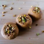 Besan Ladoo - the sweet treat balls made of chickpea flours with chopped nuts as the garnish