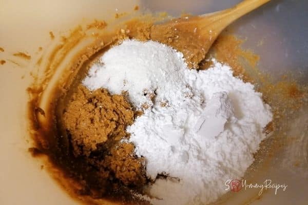 besan flour and butter mixture with desiccated coconut and icing sugar