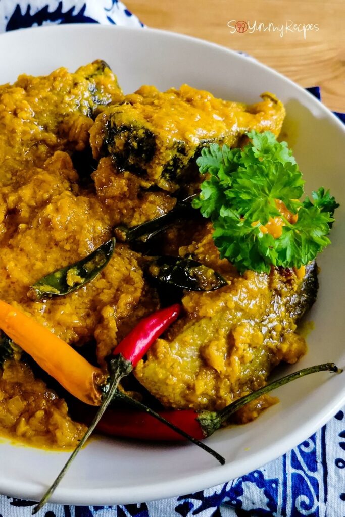 Yellow pickle fish - Ikan Pesmol - on a white bowl