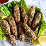Chicken Seekh Kabab with lettuces and lemon slices