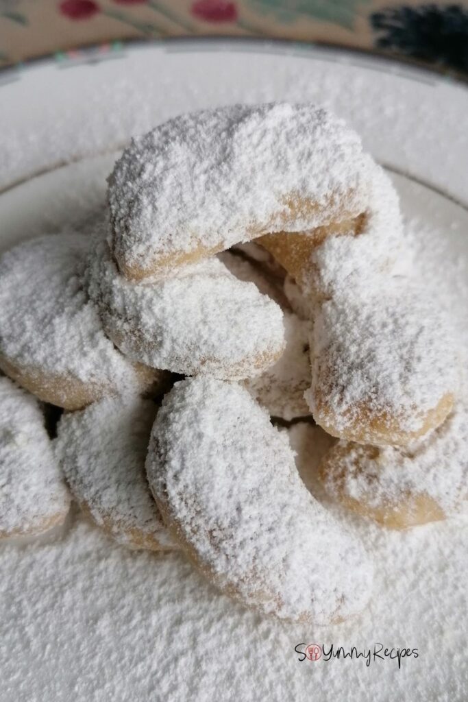 A pile of Indonesian Kue Putri Salju - the Snow White Butter Cookies - on a white plate