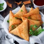 a bowl of meat samosas.