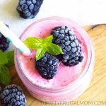 blackberry smoothie with some blackberries on top.