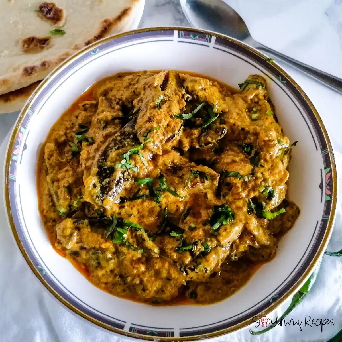 a dish of Dahi Baingan - Pakistani aubergine in spicy yoghurt sauce