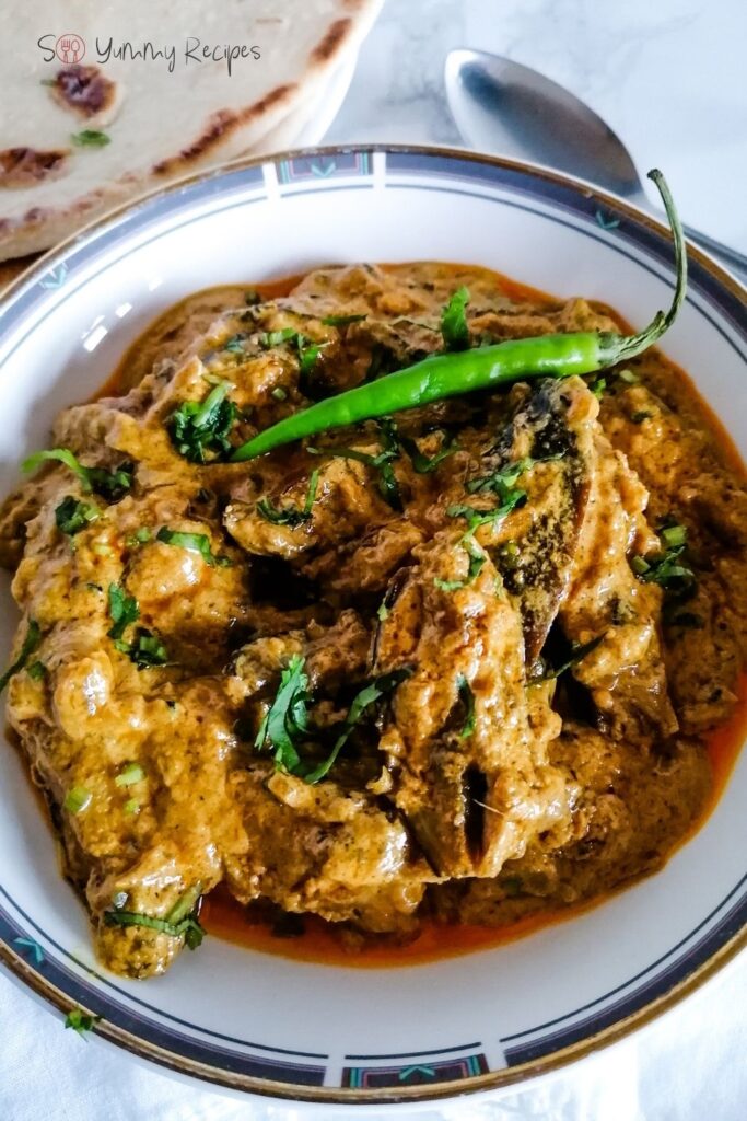 Dahi Baingan the aubergine in spicy yoghurt garnished with a green chilli