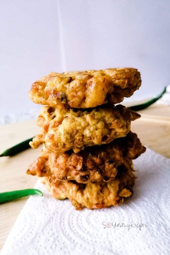 a stack of tempeh fritters - Perkedel Tempe on a white kitchen towel