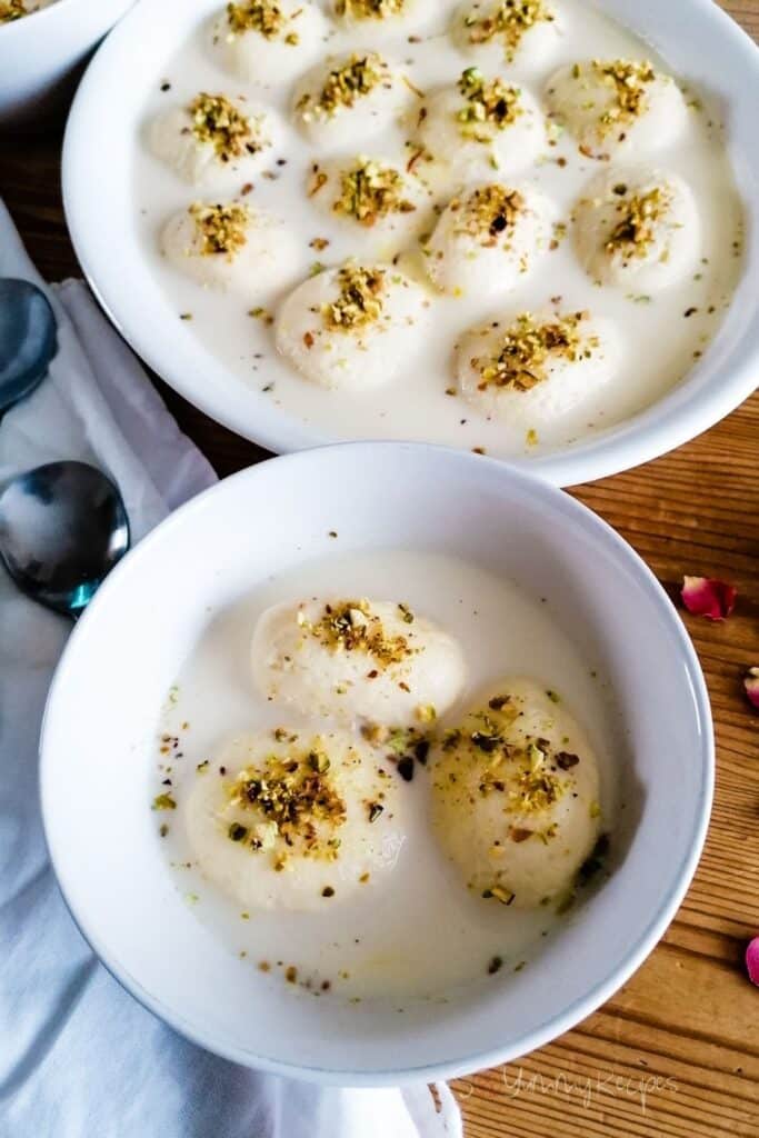 a small bowl and a large dish of rasmalai balls - the milk dumplings in sweetened milk
